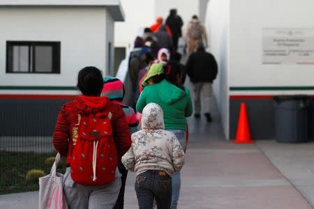 Immigrants from Central America and Mexican citizens, who are fleeing from violence and poverty, queue to cross into the U.S. to apply for asylum at the new border crossing of El Chaparral in Tijuana, Mexico, November 24, 2016. REUTERS/Jorge Duenes