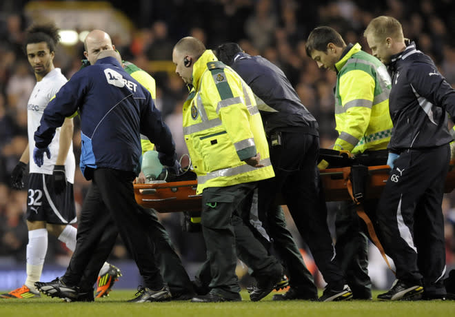 Bolton's English midfielder Fabrice Muamba is stretched from the pitch while being treated by medical staff after collapsing during the English FA Cup quarter-final football match between Tottenham Hotspur and Bolton Wanderers at White Hart Lane in north London, England on March 17, 2012. The game was abandoned at half-time as Muamba was taken to hospital. RESTRICTED TO EDITORIAL USE. No use with unauthorized audio, video, data, fixture lists, club/league logos or “live” services. Online in-match use limited to 45 images, no video emulation. No use in betting, games or single club/league/player publications (Photo by Olly Greenwood/AFP/Getty Images)