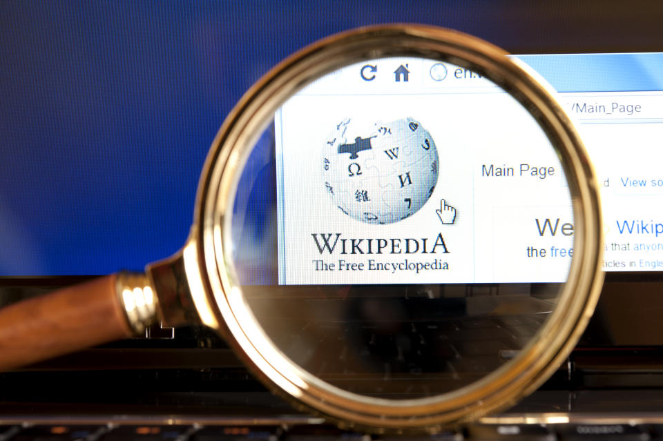 "Izmir, Turkey - June 12, 2012: Close up to Wikipedia website through a magnifying glass on the laptop.  Wikipedia is the most popular encyclopedia on the web."