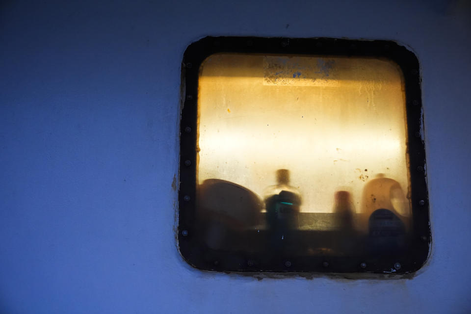 Household products sit in a window of the Dayna S, a McAdam's Fish boat where seafarer Reyner Dagalea of the Philippines lived for months last year while waiting for backpay, in Westport, Wash., on Wednesday, Jan. 31, 2024. (AP Photo/Lindsey Wasson)