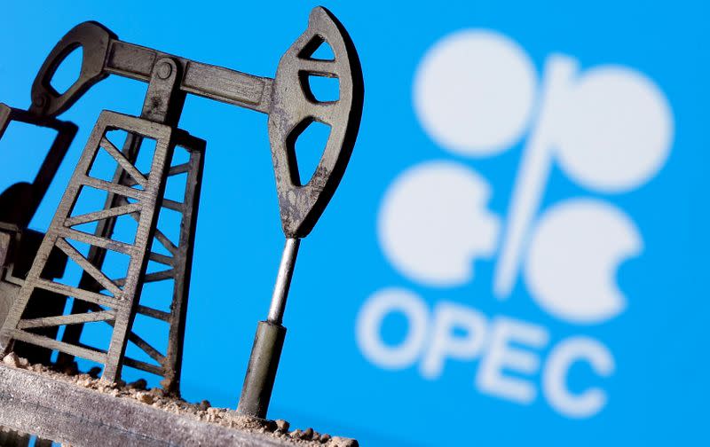 uFILE PHOTO: A 3D printed oil pump jack in front of the OPEC logo