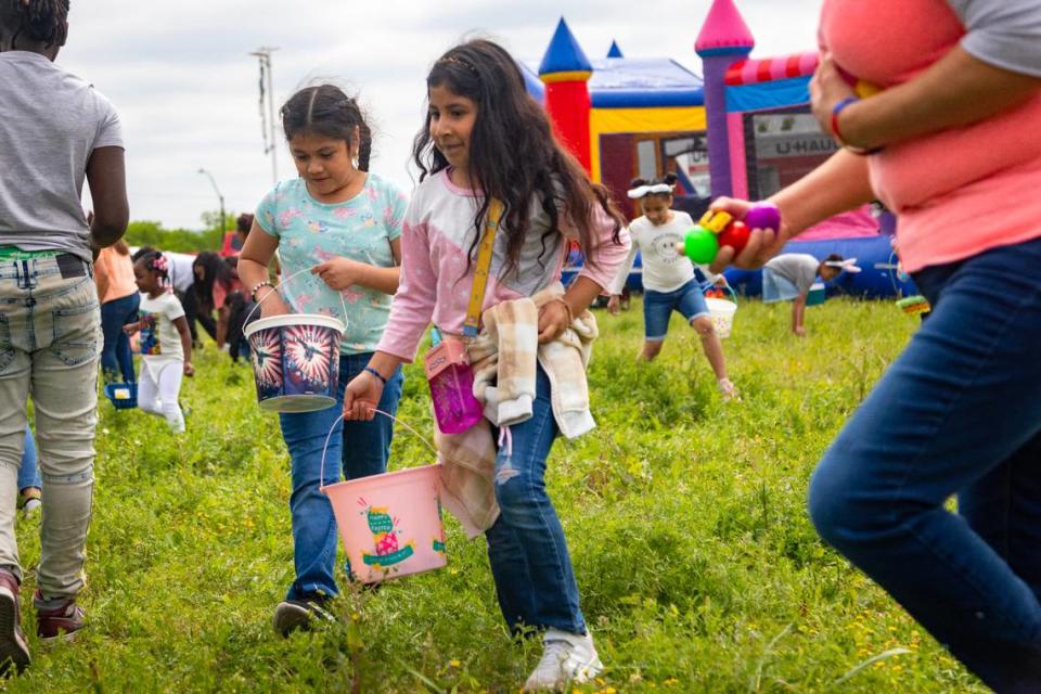 Perla Duarte, 8, (left) and Jade Duarte, 7, (right) search for eggs during the egg hunt at the Como Community Center in Fort Worth on Saturday, April 8, 2023.