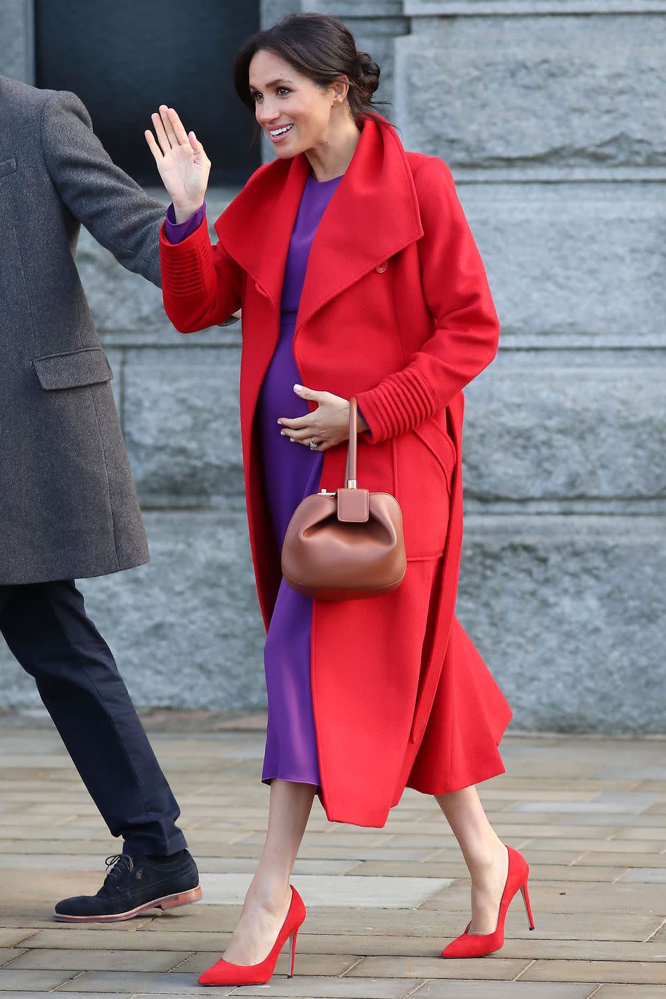 <p><strong>14 January </strong>For a visit to Birkenhead, Meghan paired her purple dress with clashing Stuart Weitzman pumps and a Sentaler coat to match. </p>