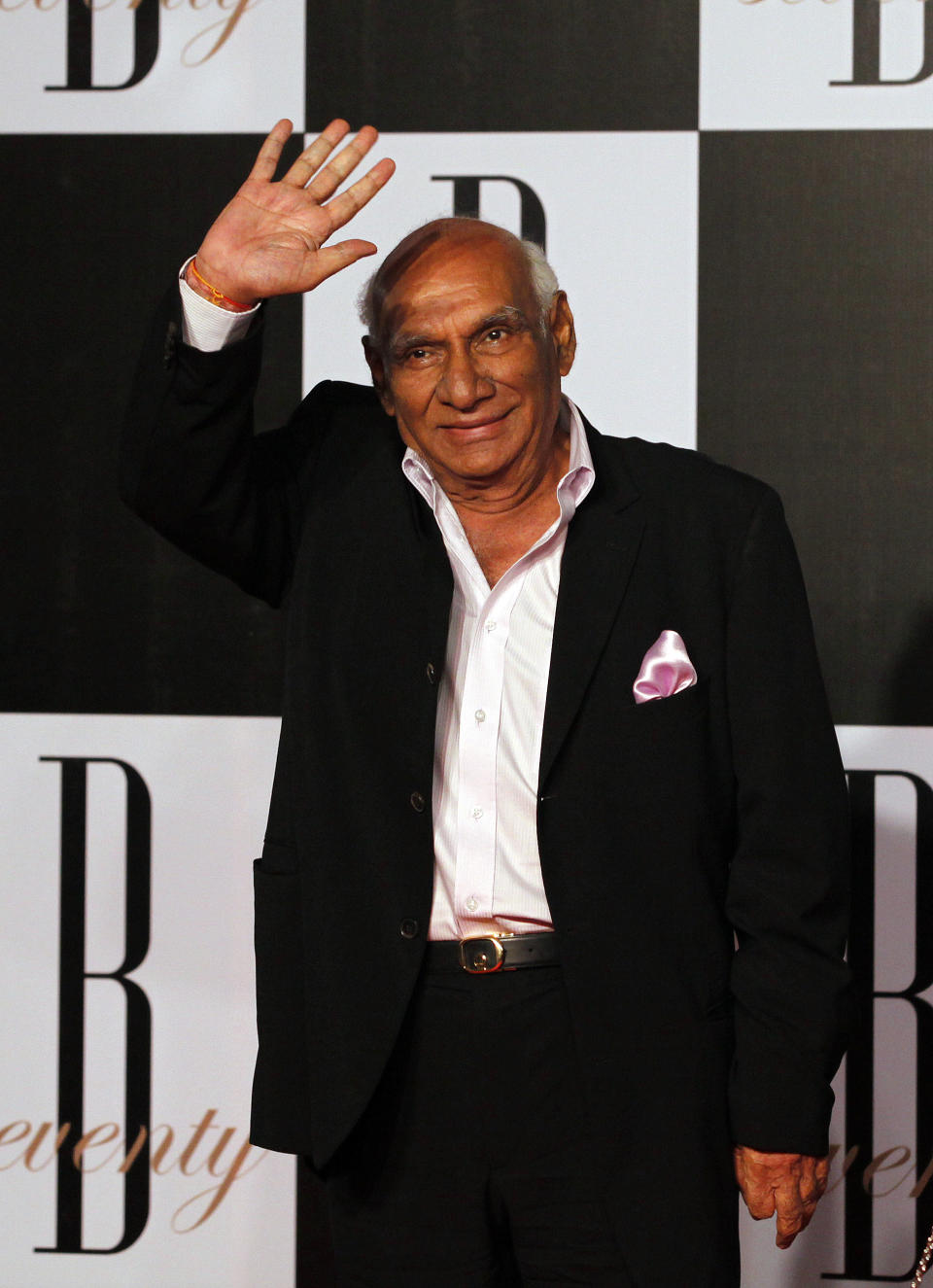 In this photo taken Oct. 10, 2012, Bollywood producer and director Yash Chopra arrives for a party on the eve of Bollywood actor Amitabh Bachchan's 70th birthday in Mumbai, India. Bollywood movie mogul Yash Chopra died Sunday, Oct. 21, 2012 in Mumbai more than a week after he contracted dengue fever, a doctor said. He was 80. (AP Photo/ Rajanish Kakade)