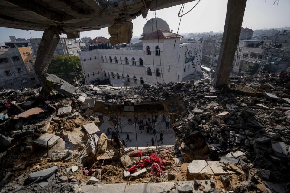 Palestinians in the ruins of a residential building after an Israeli strike in Rafah, southern Gaza Strip, on Wednesday (Copyright 2024 The Associated Press. All rights reserved.)