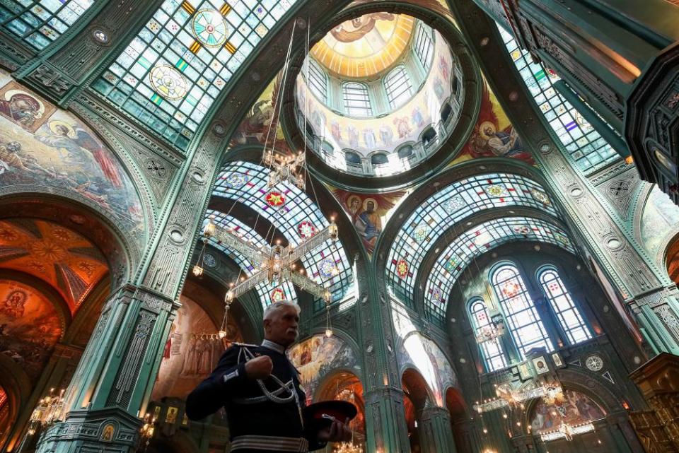 A member of the armed forces attends a service in the cathedral.