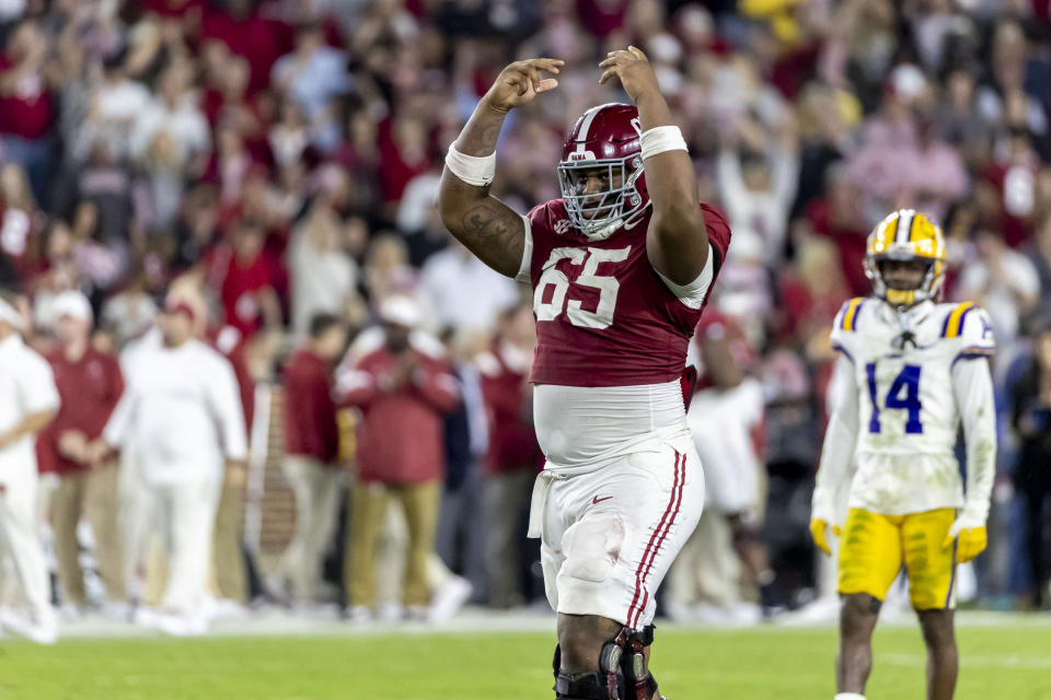 Alabama offensive lineman JC Latham (65) cheers the student section in the final minute of Alabama's win over LSU during the second half of an NCAA college football game, Saturday, Nov. 4, 2023, in Tuscaloosa, Ala. (AP Photo/Vasha Hunt)