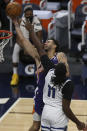 Phoenix Suns' Abdel Nader (11) is fouled by Minnesota Timberwolves's Naz Reid (11) in the second half of an NBA basketball game Sunday, Feb. 28, 2021, in Minneapolis. (AP Photo/Stacy Bengs)