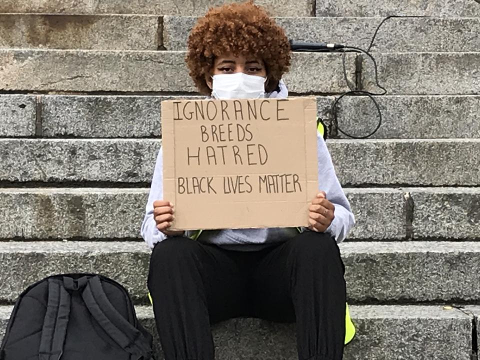 A protester attends an anti-racism rally in Belfast (Rebecca Black/PA)