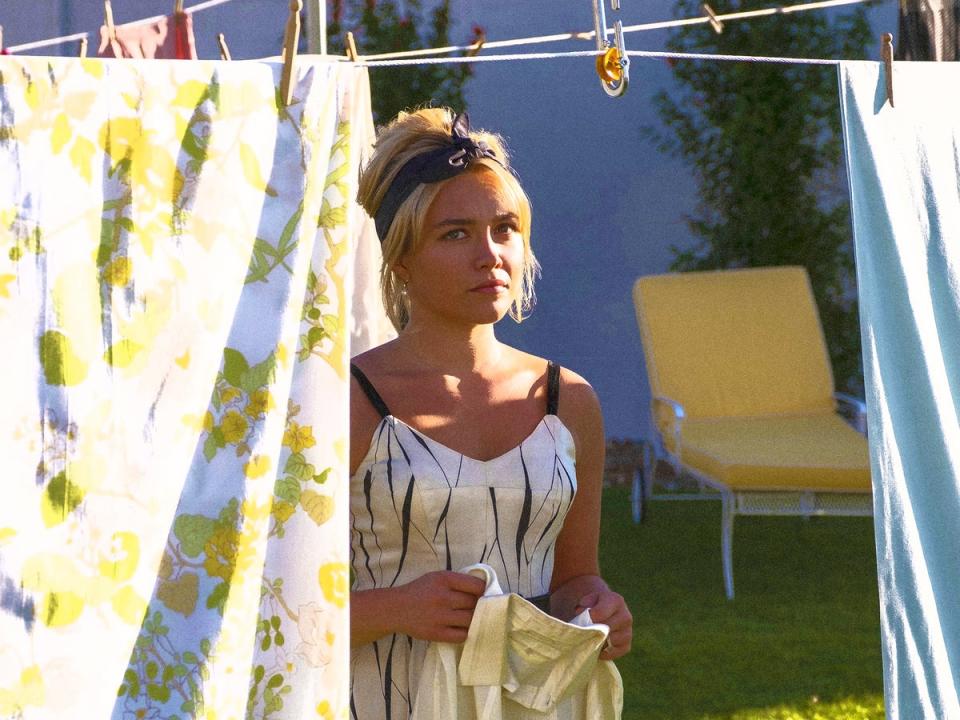 Florence Pugh hangs out the washing in ‘Don’t Worry Darling’  (Merrick Morton/Warner Bros)