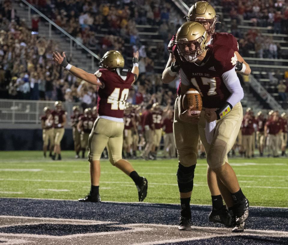 Mater Dei's Mason Wunderlich (17) celebrates after a touchdown as the Mater Dei Wildcats play the North Posey Vikings at the Reitz Bowl in Evansville, Ind., Friday evening, Nov. 4, 2022.