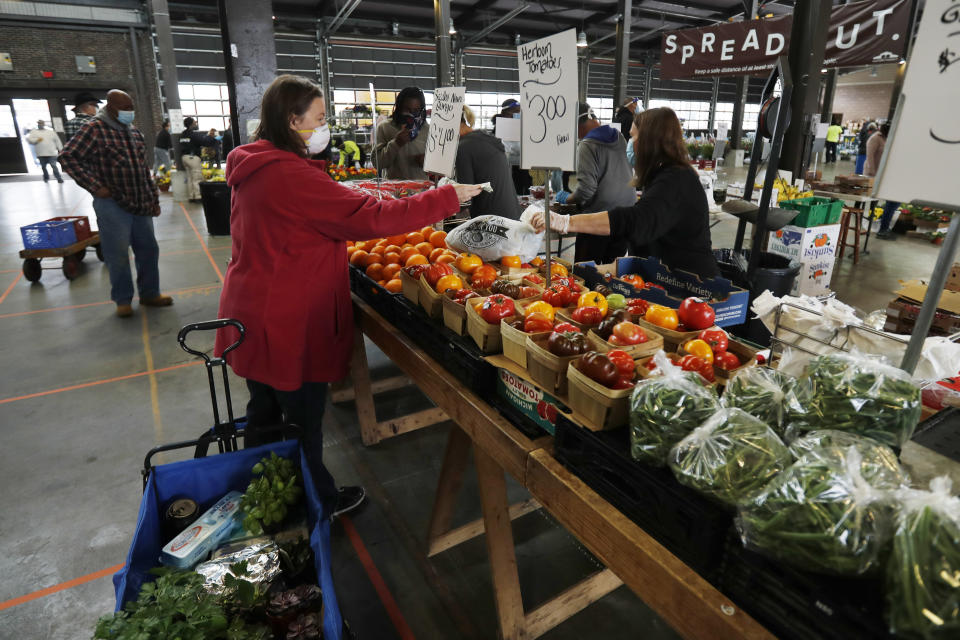 FILE - Carrie Simpson shops at the Detroit Farmers Market, on May 2, 2020, in Detroit. Detroit sued the U.S. Census Bureau on Tuesday, Sept. 20, 2022, over population estimates from last year that show the city lost an additional 7,100 residents, opening another front against the agency in a battle over how its people have been counted in the past two years. (AP Photo/Carlos Osorio, File)