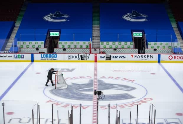 The Aquilini-owned Vancouver Canucks and Elisa steak house in Yaletown are both currently shut down because of COVID-19 concerns.  (The Canadian Press - image credit)