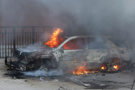 A car burns at the scene of an explosion in Mogadishu, Somalia September 22, 2018. REUTERS/Feisal Omar