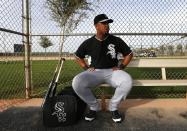 Chicago White Sox's Jose Abreu sits in the dugout during spring training baseball practice in Glendale, Ariz., Wednesday, Feb. 19, 2014. (AP Photo/Paul Sancya)