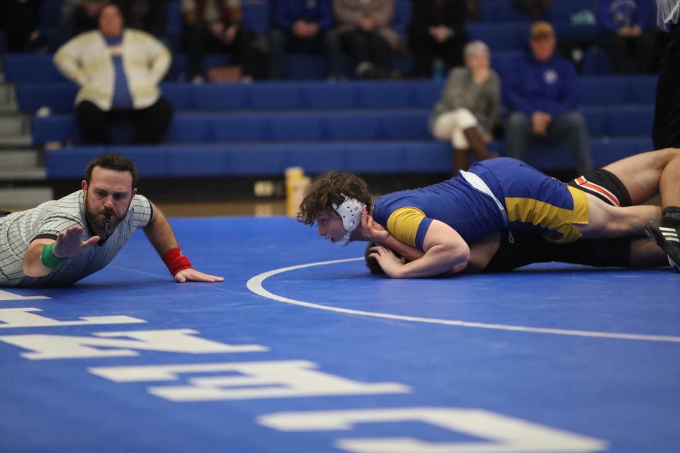 Ayden Gisi pins his opponent, TJ Lien of Huron in the third period in a dual on Thursday night in Aberdeen.