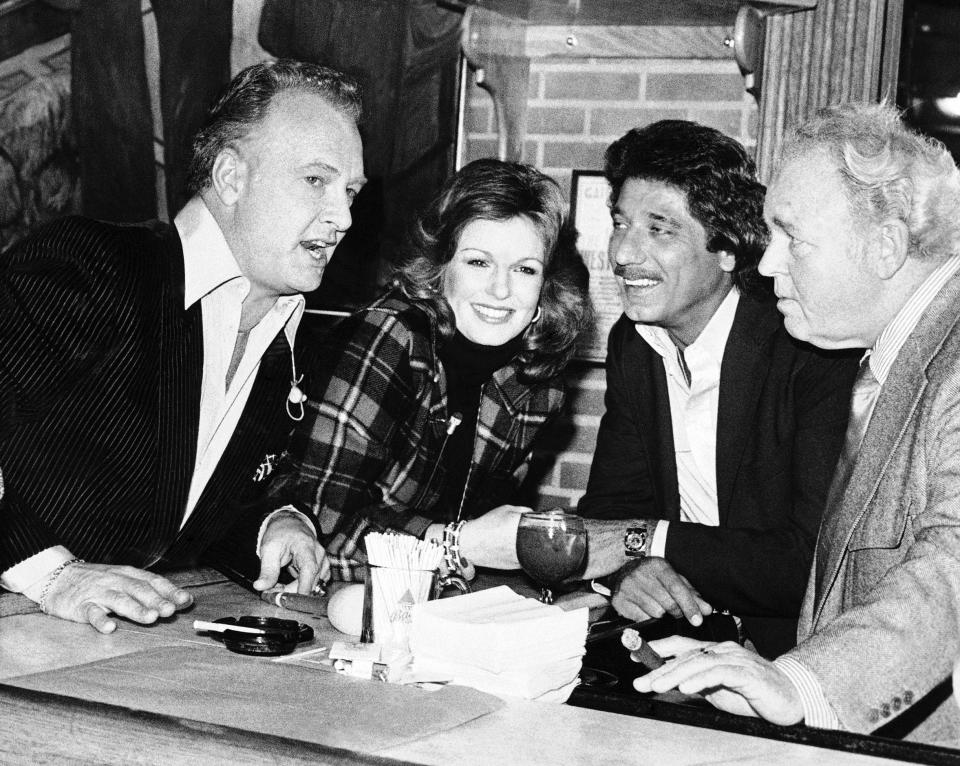 FILE - In this Jan. 21, 1980 file photo , at a pregame Super Bowl taping, from left to right, Paul Horning, former Miss American Phyllis George, Joe Namath and Carroll O'Connor are seen in Beverly Hills, Calif. Phyllis George, the former Miss America who became a female sportscasting pioneer on CBS's “The NFL Today” and served as the first lady of Kentucky, has died, Thursday, May 14, 2020. She was 70. (AP Photo/File)