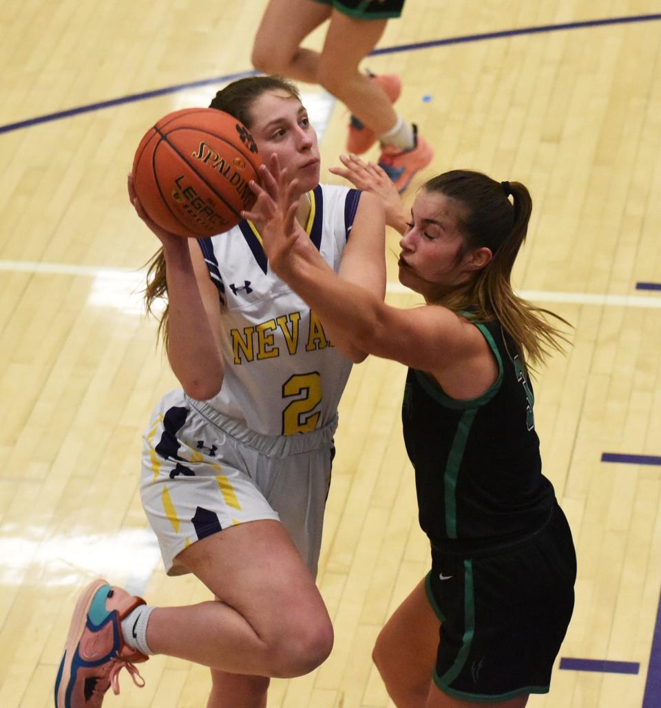 Nevada's Emma Strottman powers up a shot against a Grand View Christian defender during the Cub girls' 49-42 victory over the Thunder Thursday at the Nevada High School Field House in Nevada.