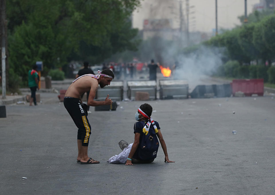 Protesters burn tires and block a street during a demonstration in Baghdad, Iraq, Tuesday, Oct. 1, 2019. Iraqi security forces fired rubber bullets and tear gas in Baghdad Tuesday on protesters demonstrating against corruption and poor public services injuring more than a dozen people, medical official said. (AP Photo/Hadi Mizban)