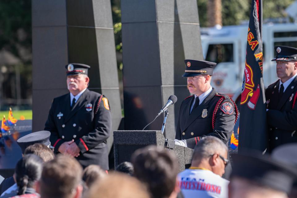 An emotional Cory Tolman explains the significance of the "last alarm" during the Arizona Fallen Firefighters and Emergency Paramedics Memorial at Wesley Bolin Memorial Plaza in Phoenix, Ariz. on Sunday, Jan. 16, 2022. The last alarm signifies fallen firefighters are "returning to quarters."