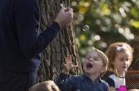 Prince George reacts to bubbles being blown by his father the Duke of Cambridge during a children's party at Government House in Victoria, British Columbia, Canada September 29, 2016. REUTERS/Jonathan Hayward/Pool