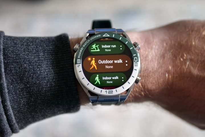 A person wearing Huawei Watch Ultimate viewing exercise modes.