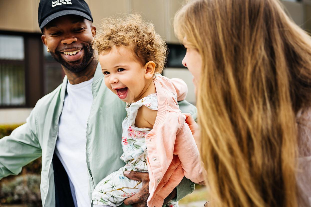 A toddler with two parents.