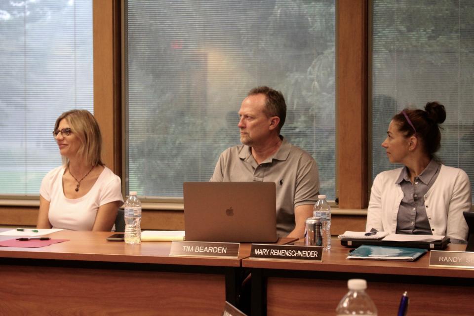 West Ottawa Board President Kate McCoy, left, Superintendent Tim Bearden, center, and Board Secretary Mary Remenschneider listen during a meeting June 28, 2021.