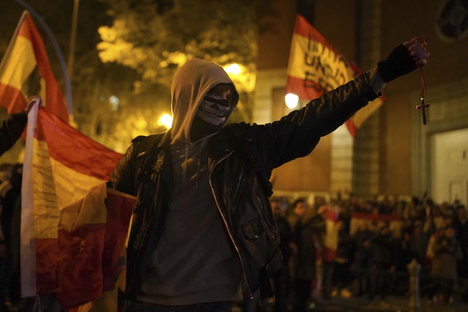 Demonstrators, some holding rosaries, protest against the amnesty at the headquarters of Socialist party in Madrid, Spain, Saturday, Nov. 11, 2023. Protests backed by Vox party turned on Saturday night as Spain's Socialists to grant amnesty to Catalan separatists in exchange for support of new government. (AP Photo/Joan Mateu Parra)