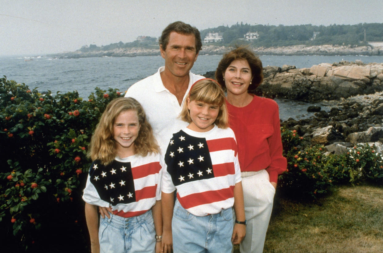 George W., Laura Bush and their daughters Barbara and Jenna wearing matching American flag shirts. (Robert Daemmrich / Getty Images)