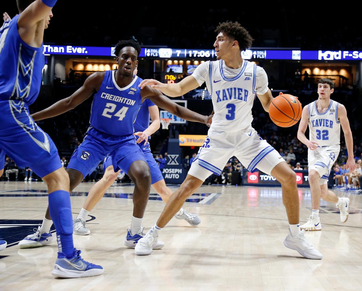 Xavier Musketeers guard Colby Jones (3) looks to make a. Pass around Creighton Bluejays forward Arthur Kaluma (24) in the first half Saturday January 15, 2022 at the Cintas Center. 