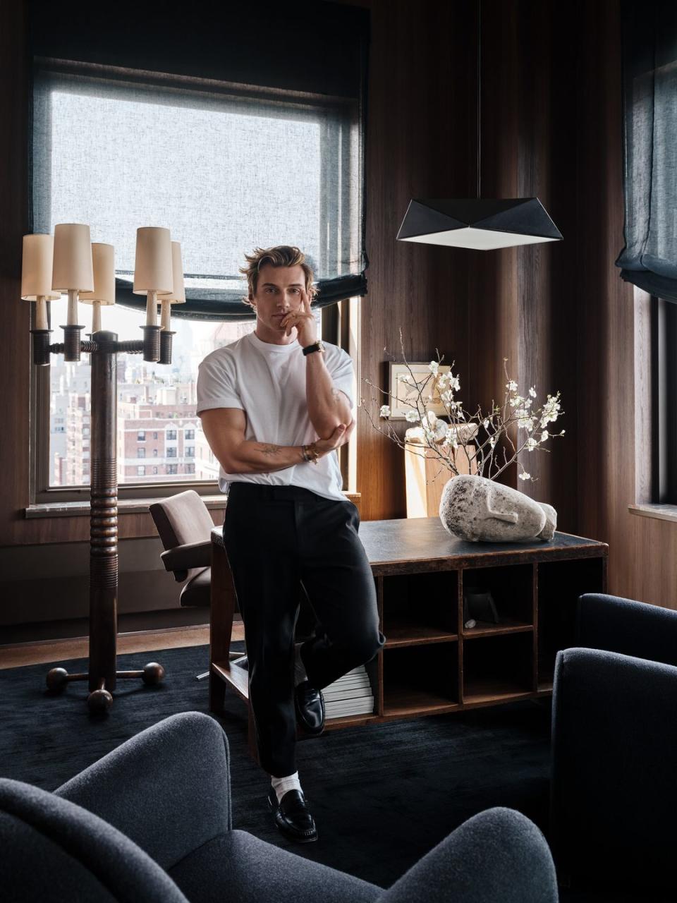 jeremiah brent leaning against a desk in his office