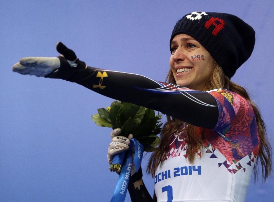 Noelle Pikus-Pace of the United States cries during the flower ceremony after winning the silver medal during the women's skeleton competition at the 2014 Winter Olympics, Friday, Feb. 14, 2014, in Krasnaya Polyana, Russia. (AP Photo/Dita Alangkara)