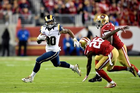 Sep 12, 2016; Santa Clara, CA, USA; Los Angeles Rams running back Todd Gurley (30) rushes against San Francisco 49ers cornerback Tramaine Brock (26) and 49ers linebacker Tank Carradine (95) during the first half of an NFL game at Levi's Stadium. Mandatory Credit: Kirby Lee-USA TODAY Sports