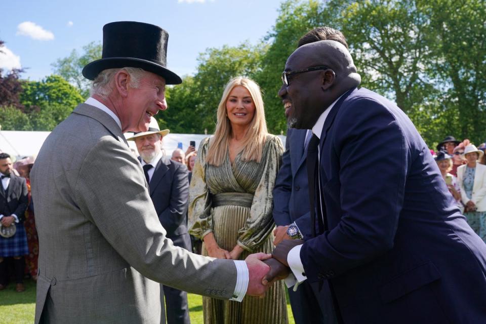 British Vogue's Global Creative and Cultural Advisor Edward Enninful (R) shakes hands with the King (POOL/AFP via Getty Images)