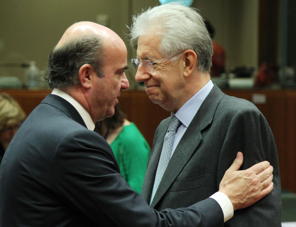 Italian Finance Minister Mario Monti, right, talks to Spanish Finance Minister Luis de Guindos Jurado, during the EU finance ministerial meeting at the European Council building in Brussels, Tuesday, July 10, 2012. Euro area finance ministers agreed early Tuesday on the terms of a bailout for Spain's troubled banks, saying that 30 billion euro ($36.88 billion) can be ready by the end of this month. (AP Photo/Yves Logghe)