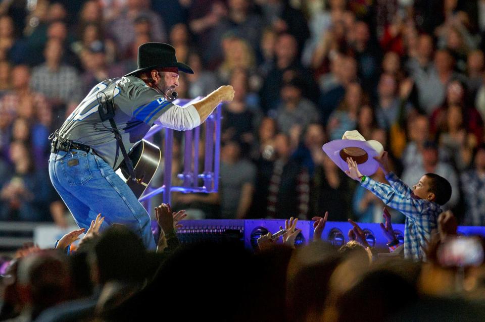 Garth Brooks interacts with a young fan at Ford Field in Detroit on Saturday, Feb. 22, 2020 as part of the Garth Brooks Stadium Tour.