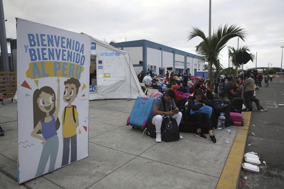 Venezuelan migrants wait another group of migrants to continue their travel to Lima in Tumbes, Peru, Friday, June 14, 2019. Venezuelan citizens are rushing to enter Peru before the implementation of new entry requirements on migrants fleeing the crisis-wracked South American nation. (AP Photo/Martin Mejia)