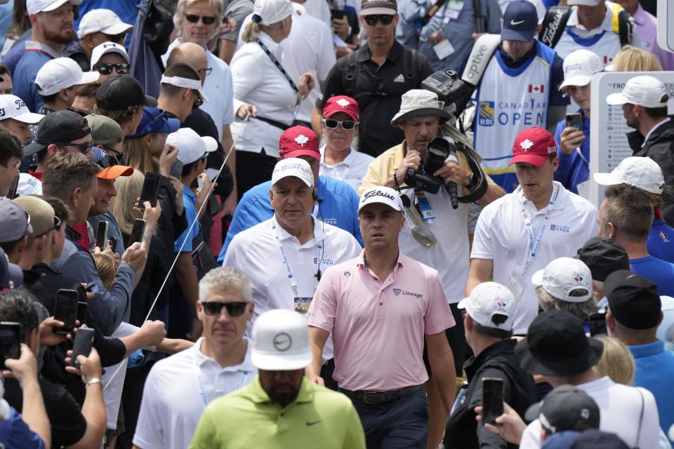 Justin Thomas, center, makes his way through the crowd on his way to the second tee during the fourth round of the Canadian Open golf tournament in Toronto on Sunday, June 12, 2022. (Frank Gunn/The Canadian Press via AP)