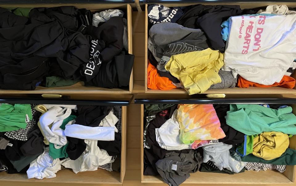 An aerial view of the four drawers sitting on the floor; they're all disorganized, with different types and styles of clothing shoved together
