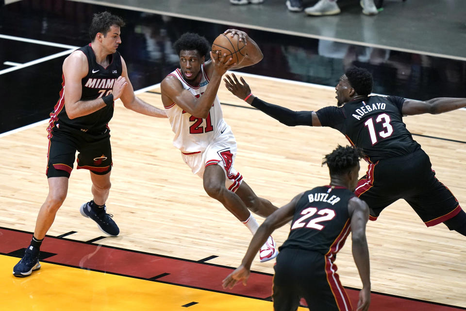 Chicago Bulls forward Thaddeus Young (21) drives to the basket as Miami Heat forward Nemanja Bjelica, left, and center Bam Adebayo (13) defend during the first half of an NBA basketball game, Monday, April 26, 2021, in Miami. (AP Photo/Lynne Sladky)