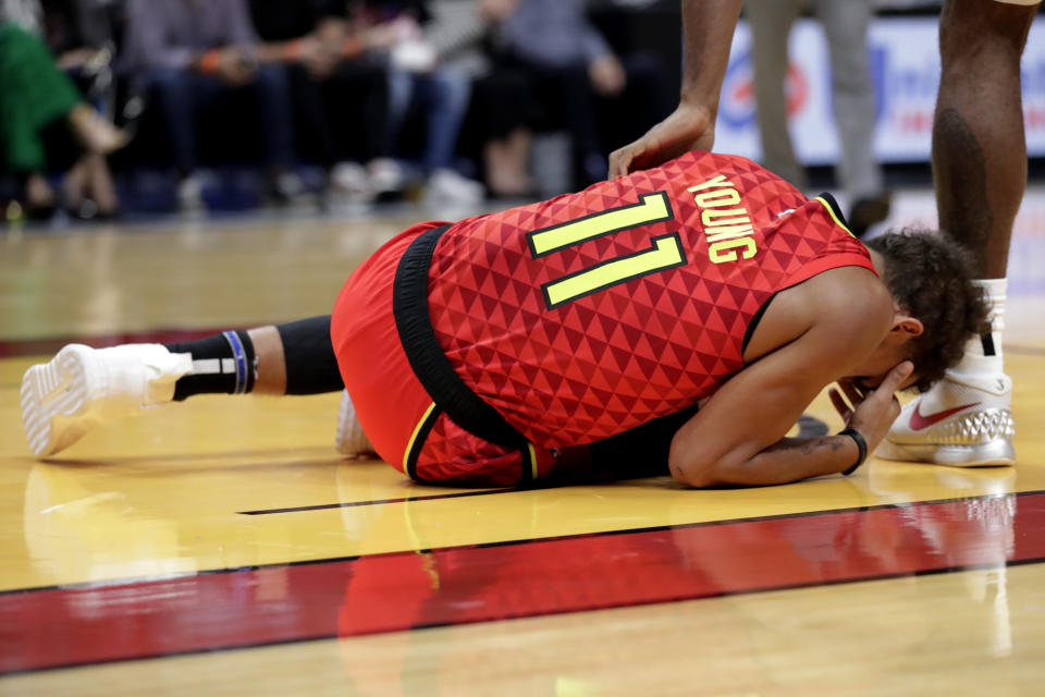 Atlanta Hawks guard Trae Young (11) lies on the court after an injury during the first half of the team's NBA basketball game against the Miami Heat, Tuesday, Oct. 29, 2019, in Miami. (AP Photo/Lynne Sladky)