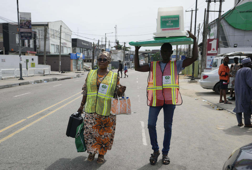 Electoral officials carry an empty ballot box and other electoral materials at the end of gubernatorial and state Assembly elections in Lagos, Nigeria, Saturday, March 18, 2023. Millions of Nigerians are headed back to the polls Saturday as Africa's most populous nation holds gubernatorial elections amid tensions after last month's disputed presidential vote. New governors are being chosen for 28 of Nigeria's 36 states as the opposition continues to reject the victory of President-elect Bola Tinubu from the West African nation's ruling party. (AP Photo/Sunday Alamba)