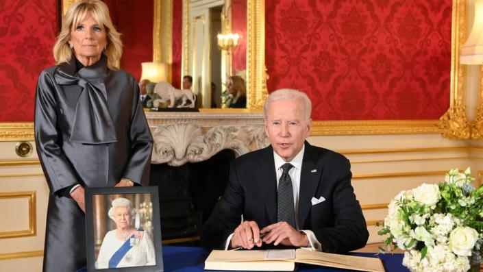 US President Joe Biden accompanied by the First Lady Jill Biden signs a book of condolence at Lancaster House in London, following the death of Queen Elizabeth II