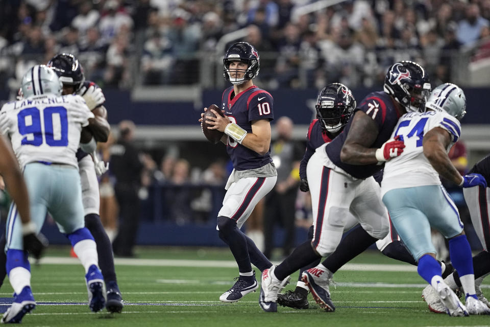 Houston Texans quarterback Davis Mills (10) looks for an open receiver during the second half of an NFL football game against the Dallas Cowboys, Sunday, Dec. 11, 2022, in Arlington, Texas. (AP Photo/Tony Gutierrez)