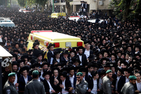 Ultra-Orthodox Jews gather near an ambulance during the funeral ceremony of prominent spiritual leader Rabbi Aharon Yehuda Leib Steinman, who died on Tuesday at the age of 104, in Bnei Brak near Tel Aviv, Israel December 12, 2017. REUTERS/Baz Ratner