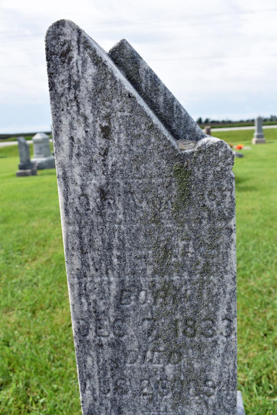 Lichen covers part of a historic headstone at Bethlehem Lutheran Church Cemetery in Slater. Some of the cemeteries stones date back to the 1800s and a group from the church is working to clean and straighten the stones.