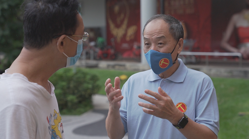 Former Workers' Party chief Low Thia Khiang greets a resident at Hougang MRT on Wednesday, 8 July. PHOTO: Nick Tan/Yahoo News Singapore