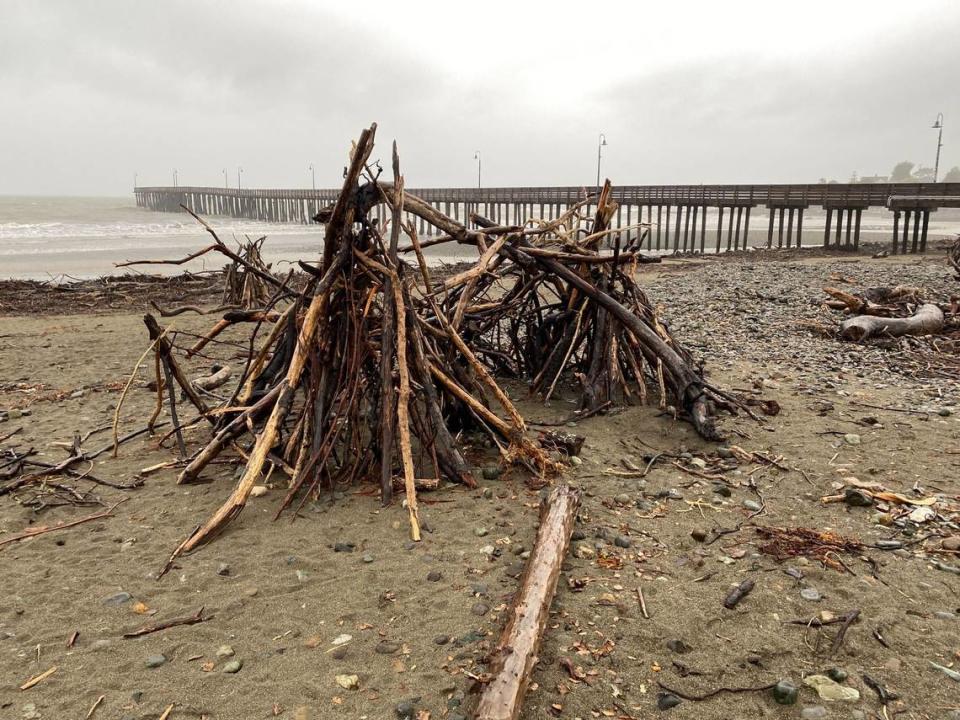 Driftwood is stacked in piles near the Cayucos Pier on Tuesday, March 14, 2023. David Middlecamp/dmiddlecamp@thetribunenews.com