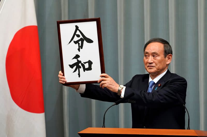 Japan's Chief Cabinet Secretary Yoshihide Suga unveils 'Reiwa' as the new era name at the prime minister's office in Tokyo